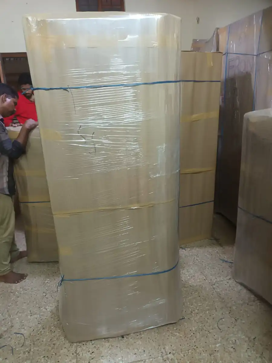 Refrigerator wrapped and roped upright by the Kerala Road Lines crew