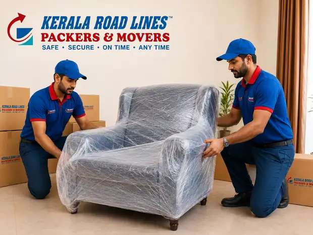 Two crew members wrapping furniture in protective film